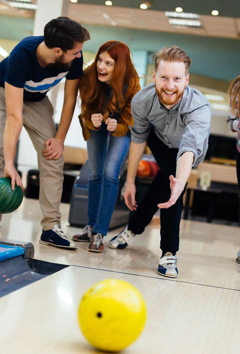 Friends and family enjoying a game of bowling