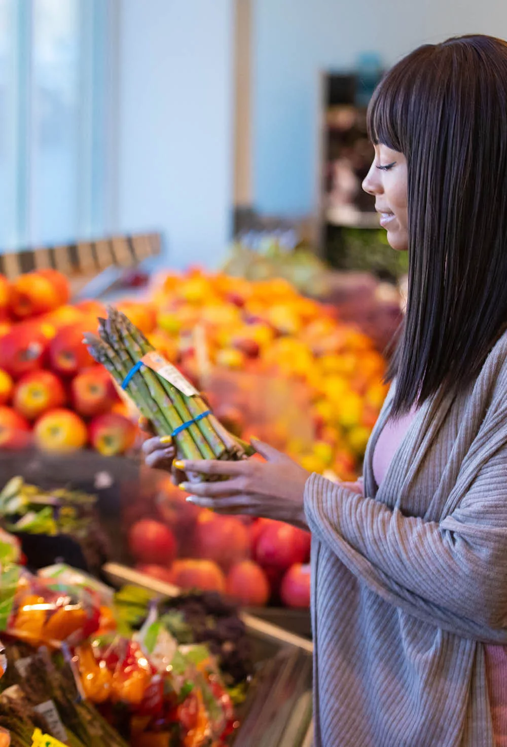 A woman looking at Asparagus