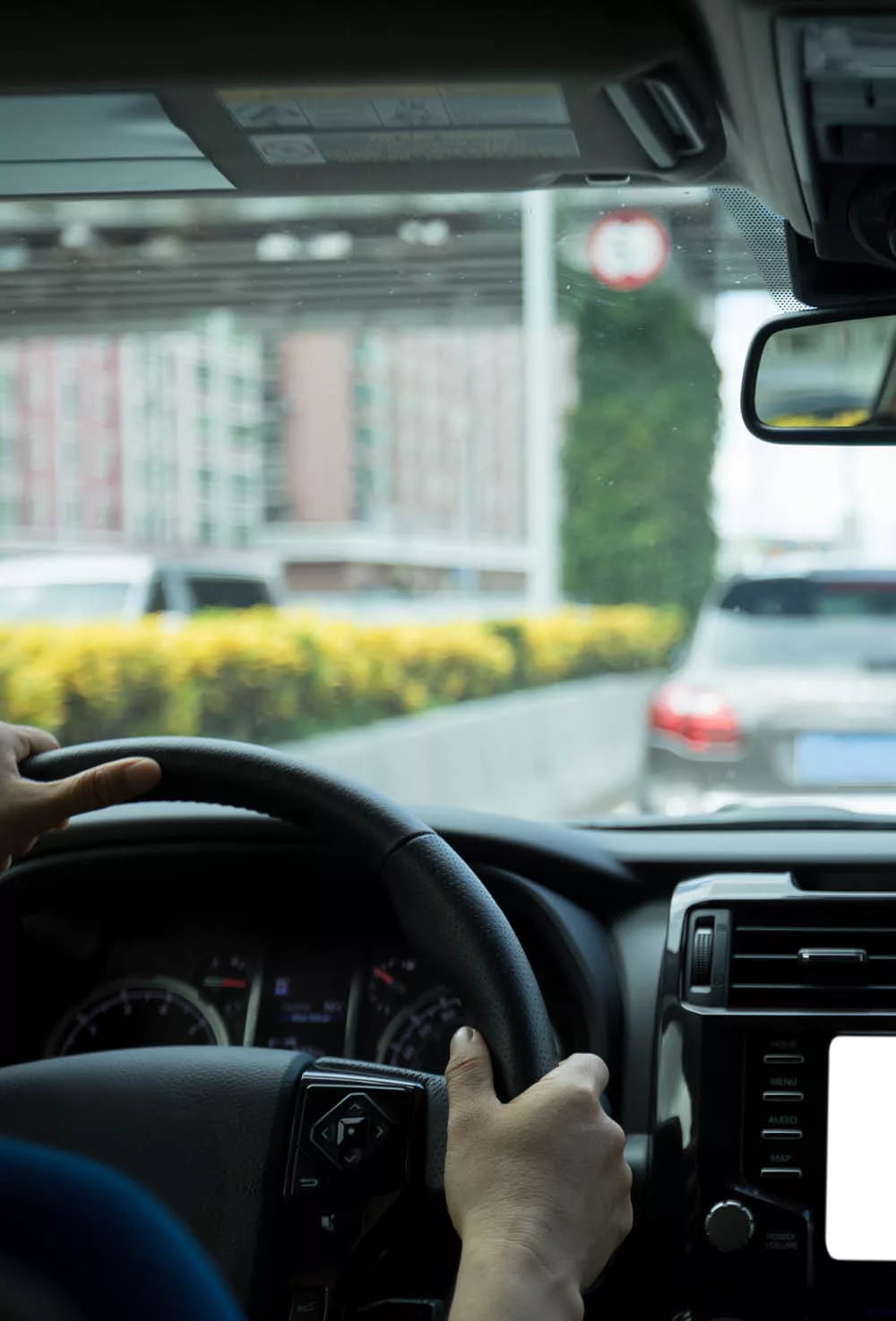 A man behind the steering wheel of his vehicle in traffic